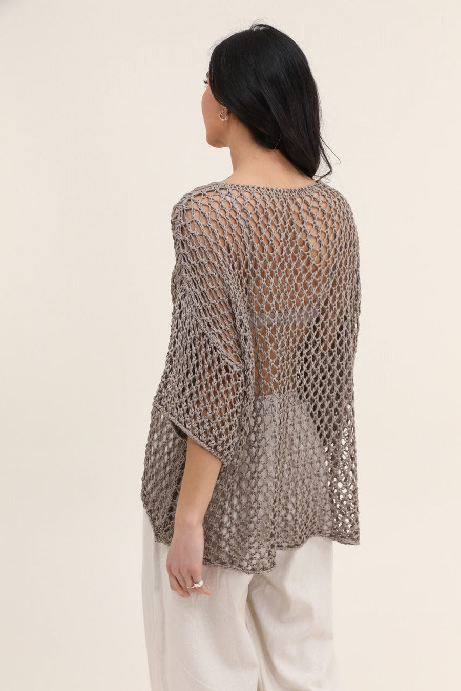 Back view of Italian-made begie cotton sweater featuring star open-work design and loose fit