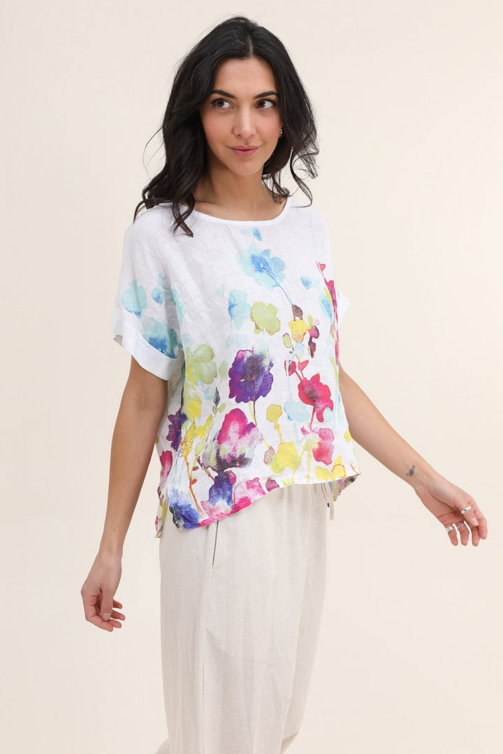 white Italian linen blouse featuring delicate floral print, short sleeves, and relaxed fit
