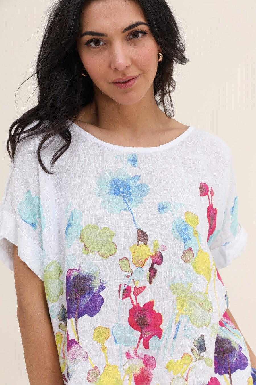 Close-up of white 100% linen fabric showcasing subtle floral pattern and lightweight texture