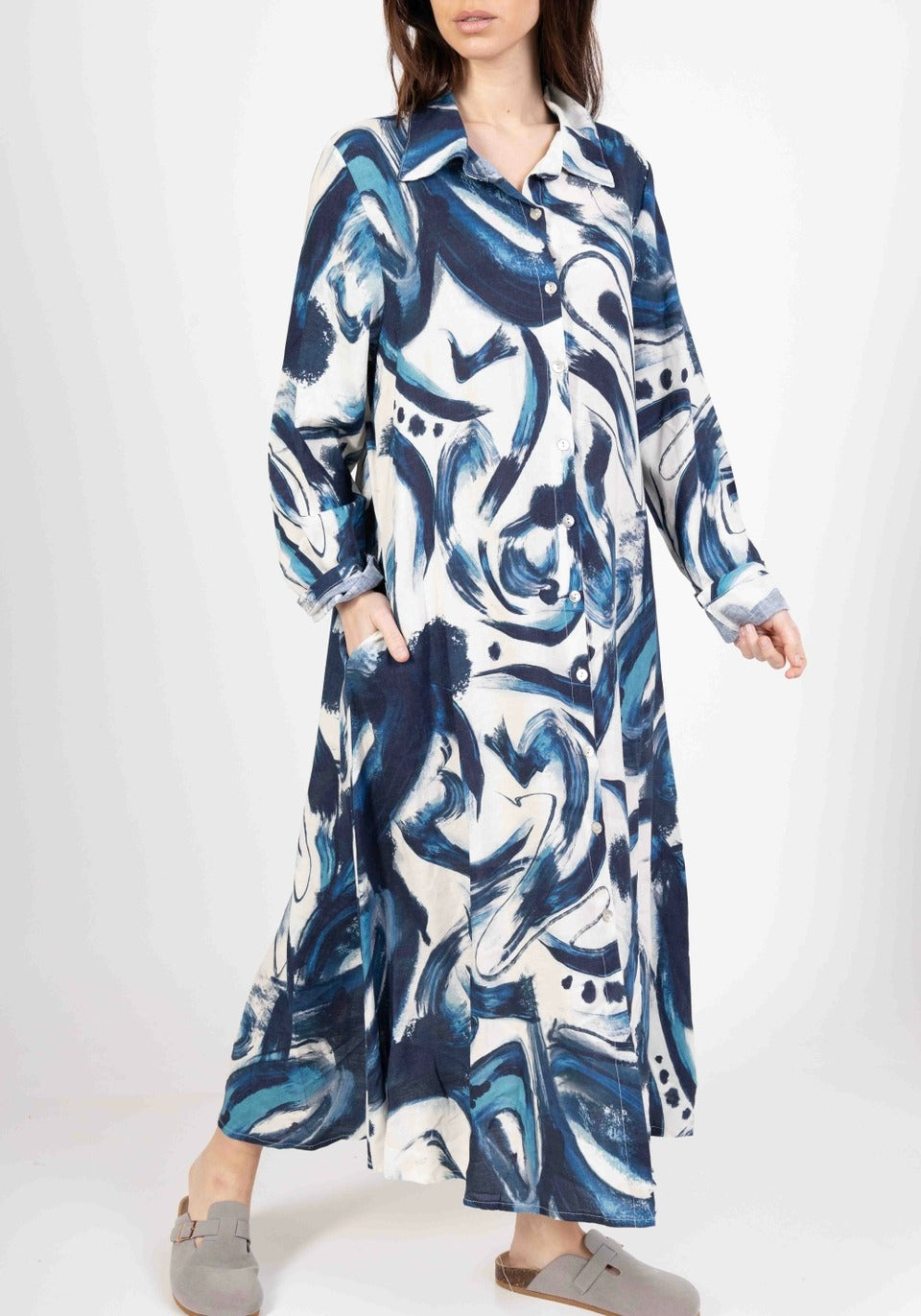 Side view of women's natural linen long dress with sleeveless cut and flowing silhouette