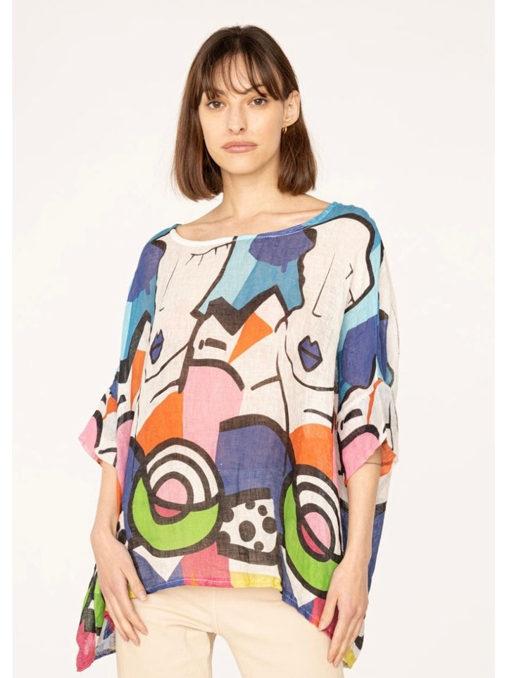 Effortless summer outfit featuring Picasso print linen top paired with white trousers – artistic flair