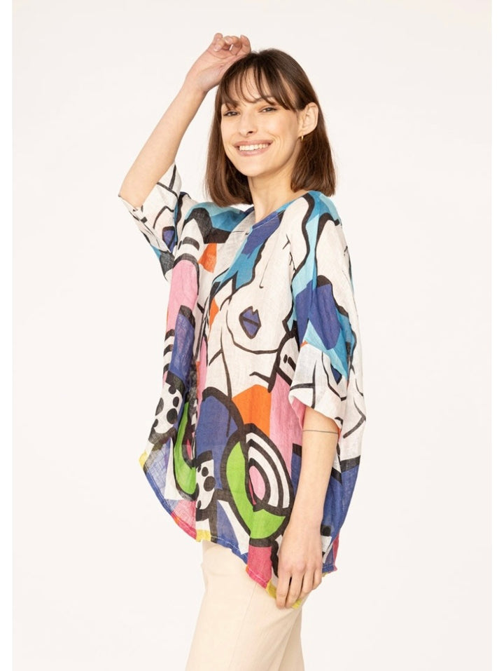 Side view of women's blue linen top showcasing artistic Picasso print and breezy silhouette