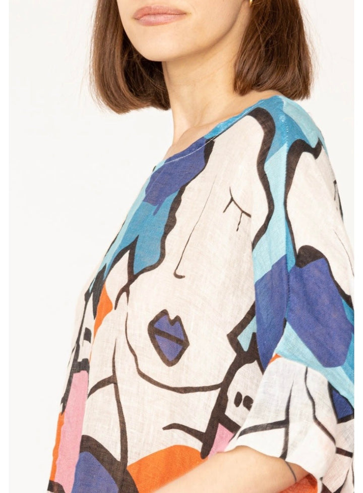 Close-up of 100% linen fabric with colorful abstract Picasso-style print and lightweight texture