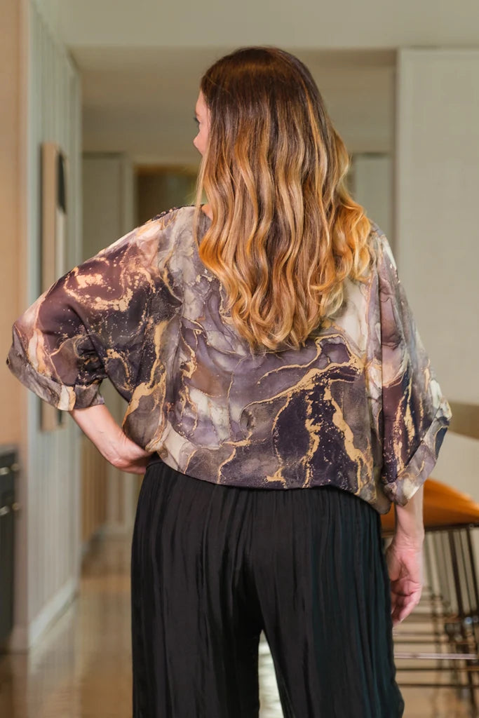 Back view of Italian-made silk blouse with soft marble patterns and relaxed fit – timeless elegance