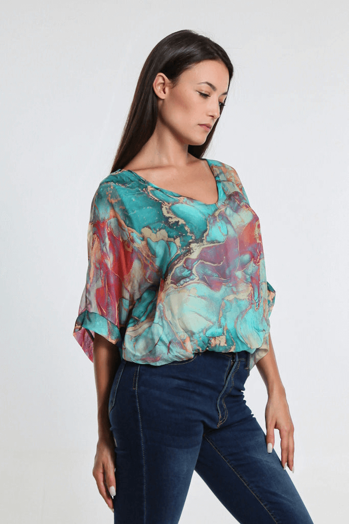 Side view of women's Tiffany blue marble print silk top with sheer sleeves and flattering banded waist