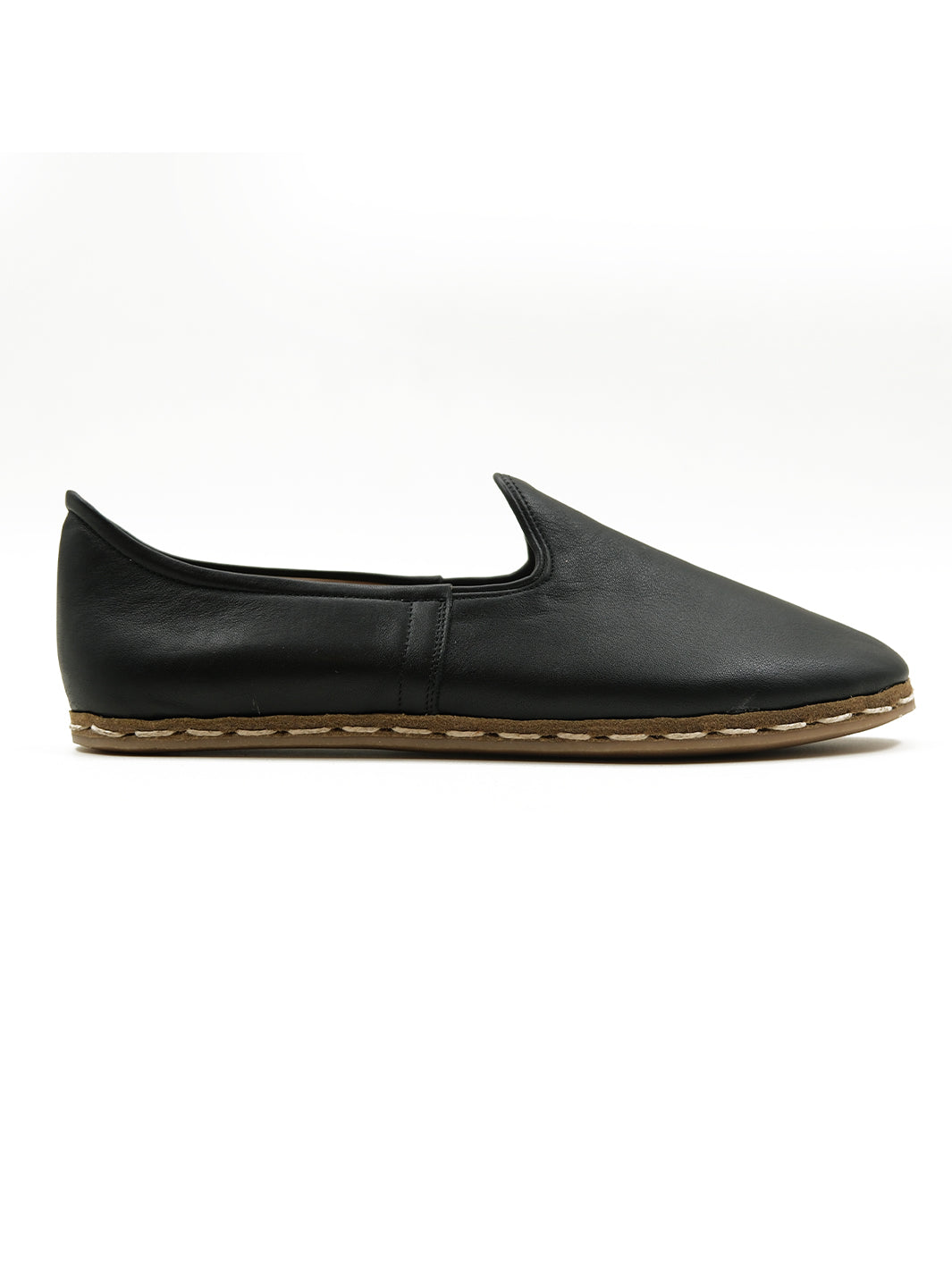 Close-up of beeswax-coated cotton twine stitching on handmade black leather slip-on