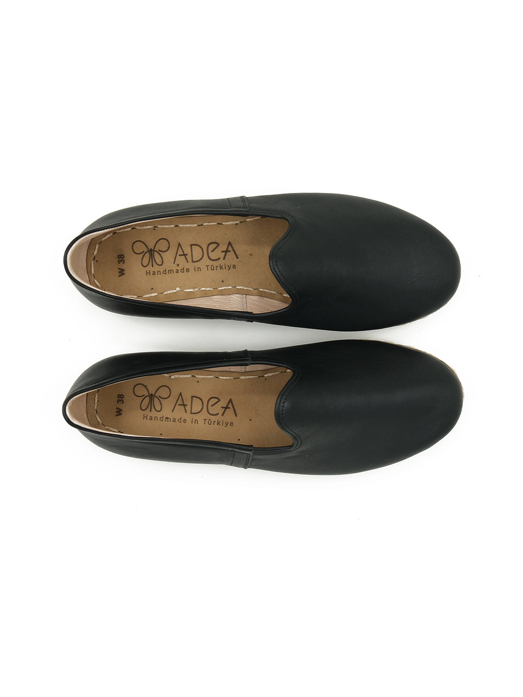 Top view of women's handmade black leather slip-on shoes by ADEA