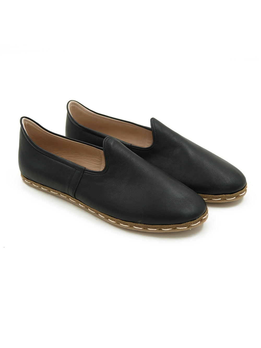 Side profile of handcrafted black leather slip-on shoes featuring premium cow leather
