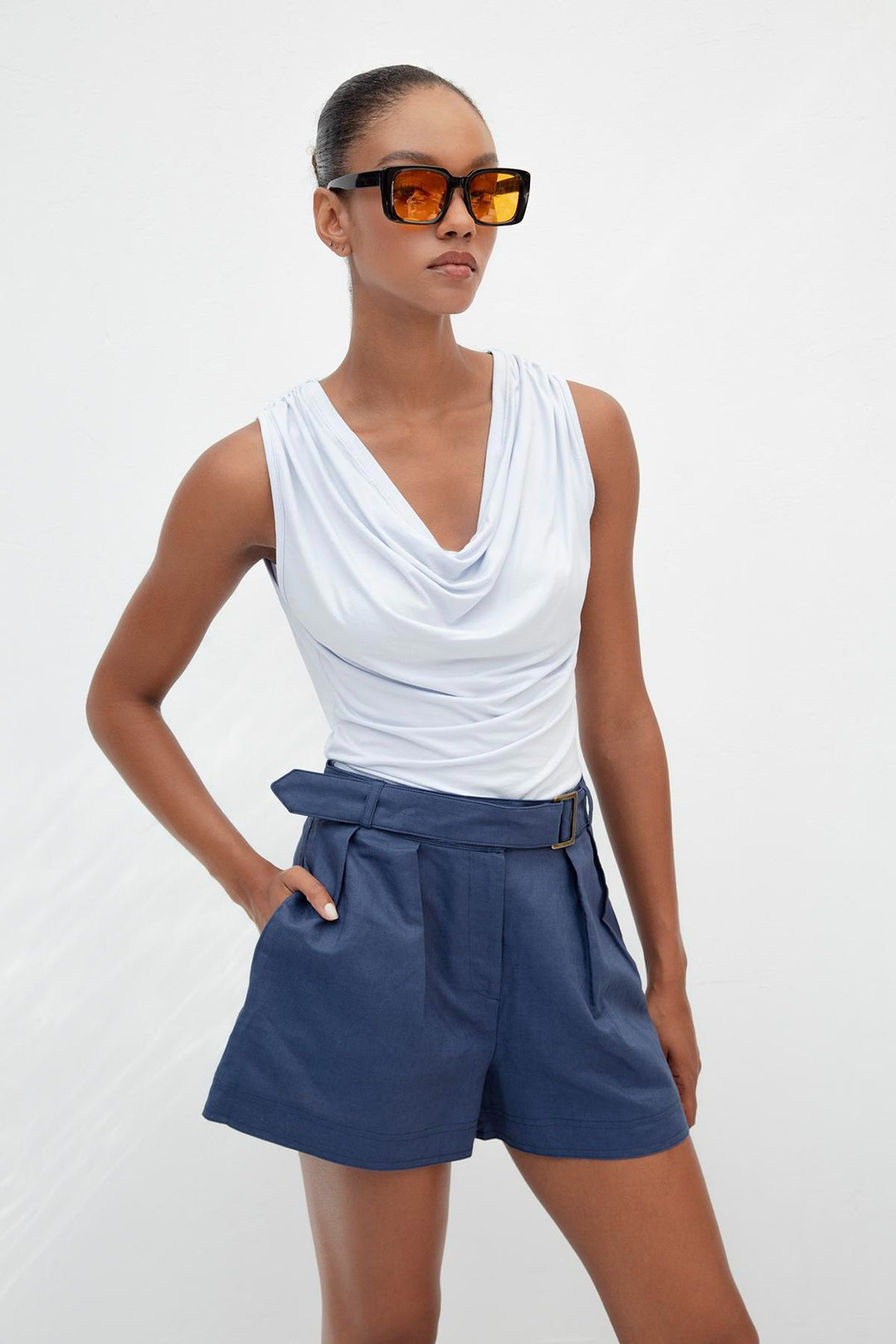 Light blue sleeveless top featuring elegant ruffle collar and relaxed fit – made in Türkiye