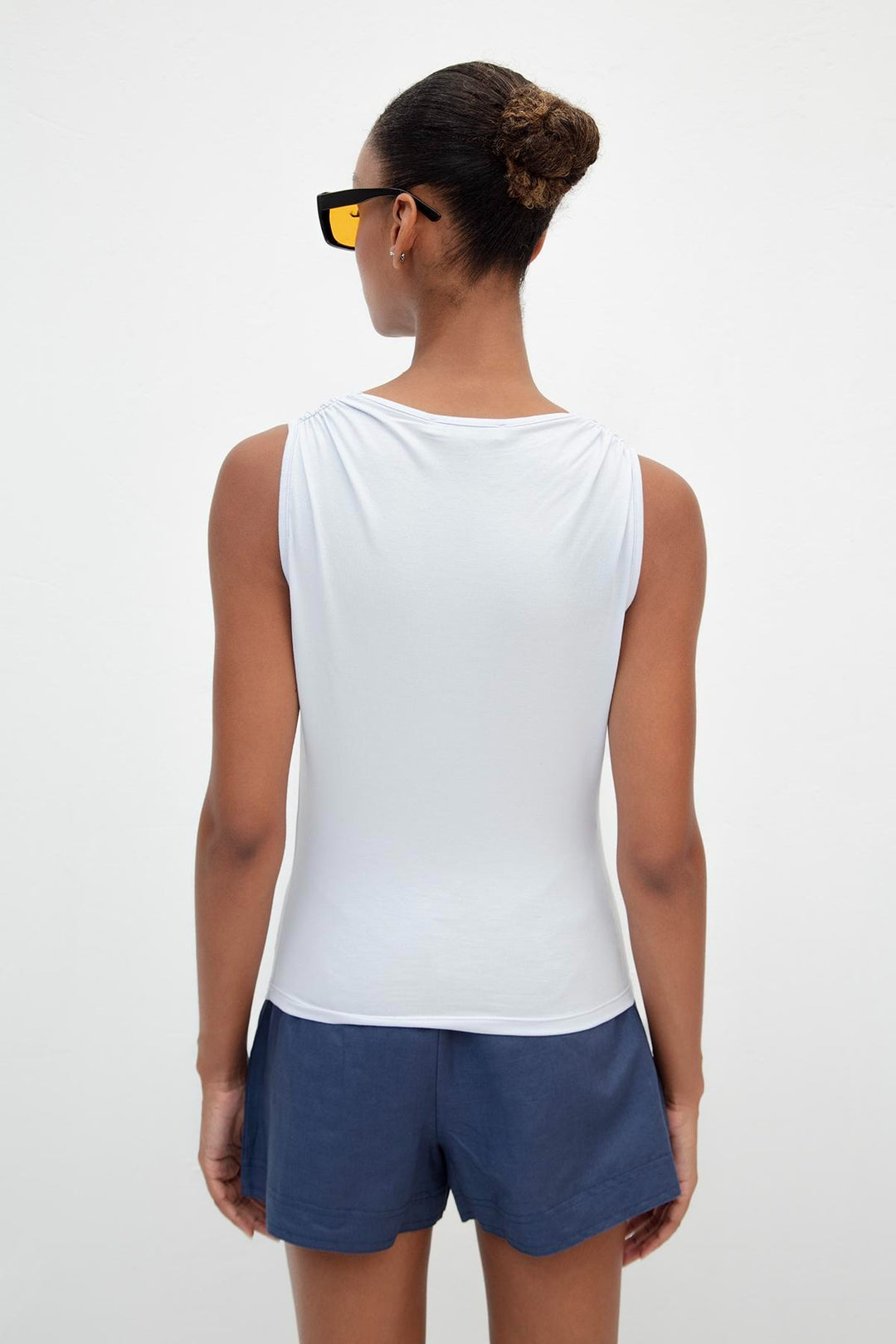 Back view of light blue viscose top featuring ruffle collar and relaxed fit – elegant design