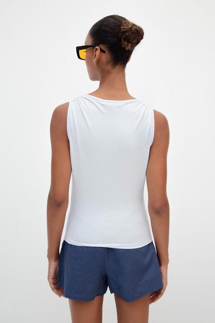 Back view of light blue viscose top featuring ruffle collar and relaxed fit – elegant design