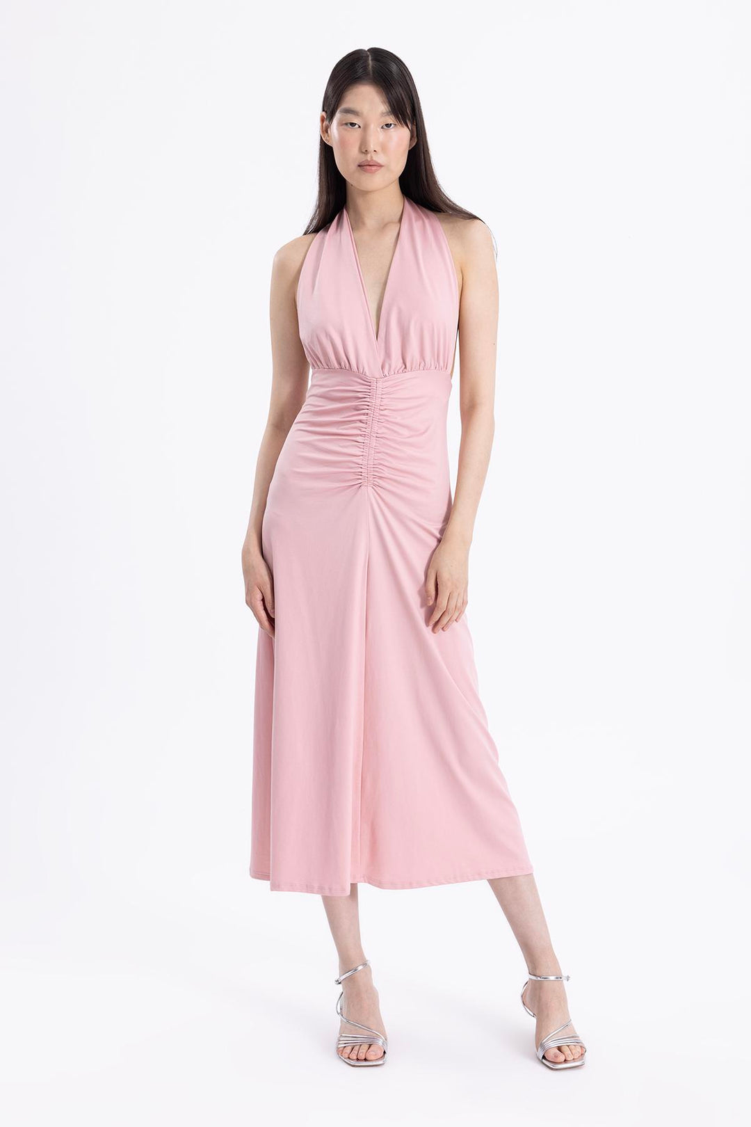 Elegant spring outfit pairing pink draped midi dress with heels – perfect for daytime events