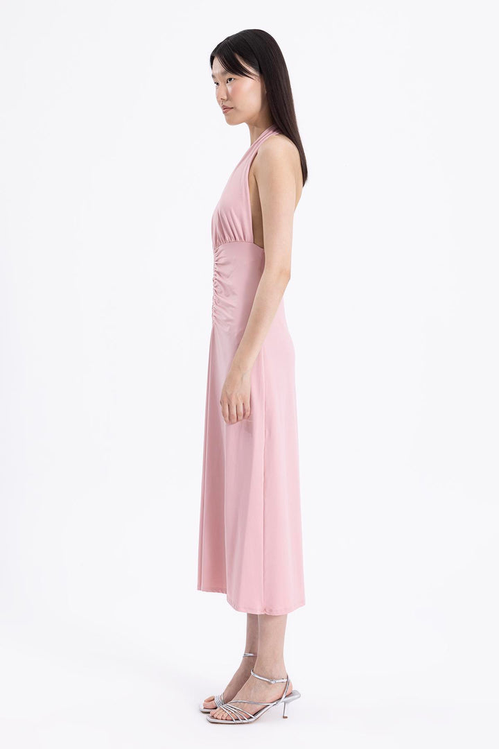 Side view of sleeveless pink midi dress with graceful drape and flattering silhouette