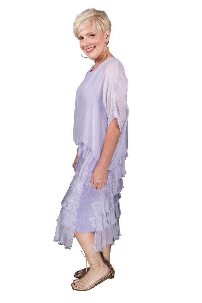 Side view of lilac tiered silk dress with flowing silhouette and layered ruffles