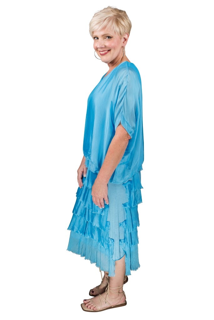 Side view of turquoise tiered silk dress with airy ruffles and flattering, flowy fit