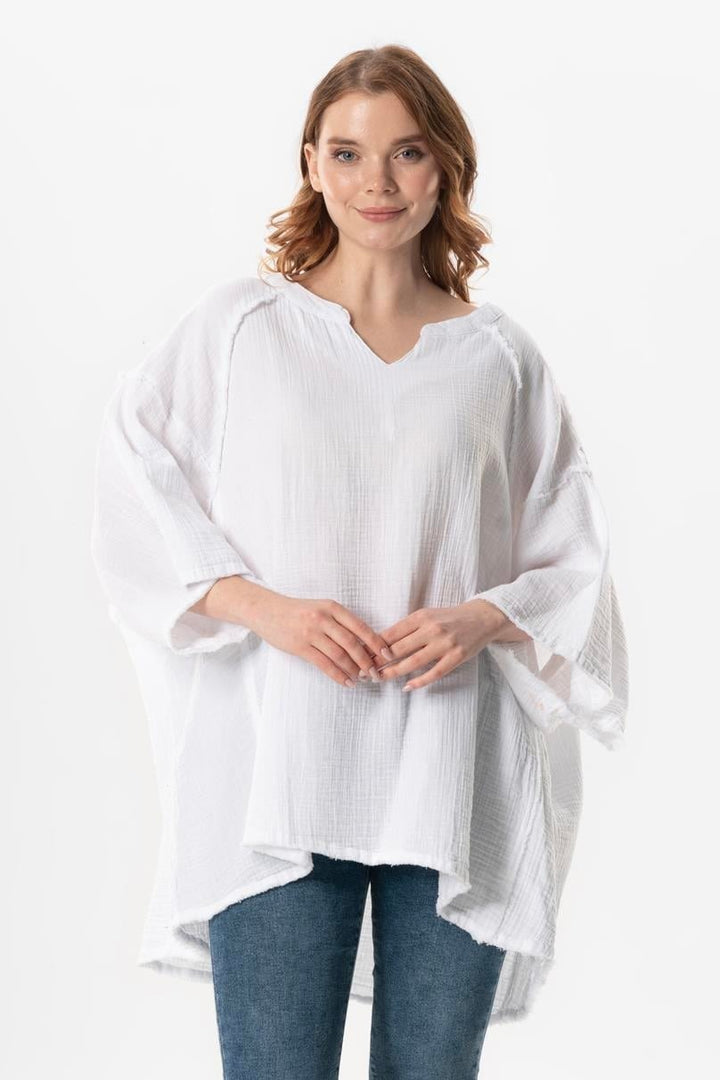 White gauze cotton top featuring wide neckline, relaxed fit, and airy lightweight fabric