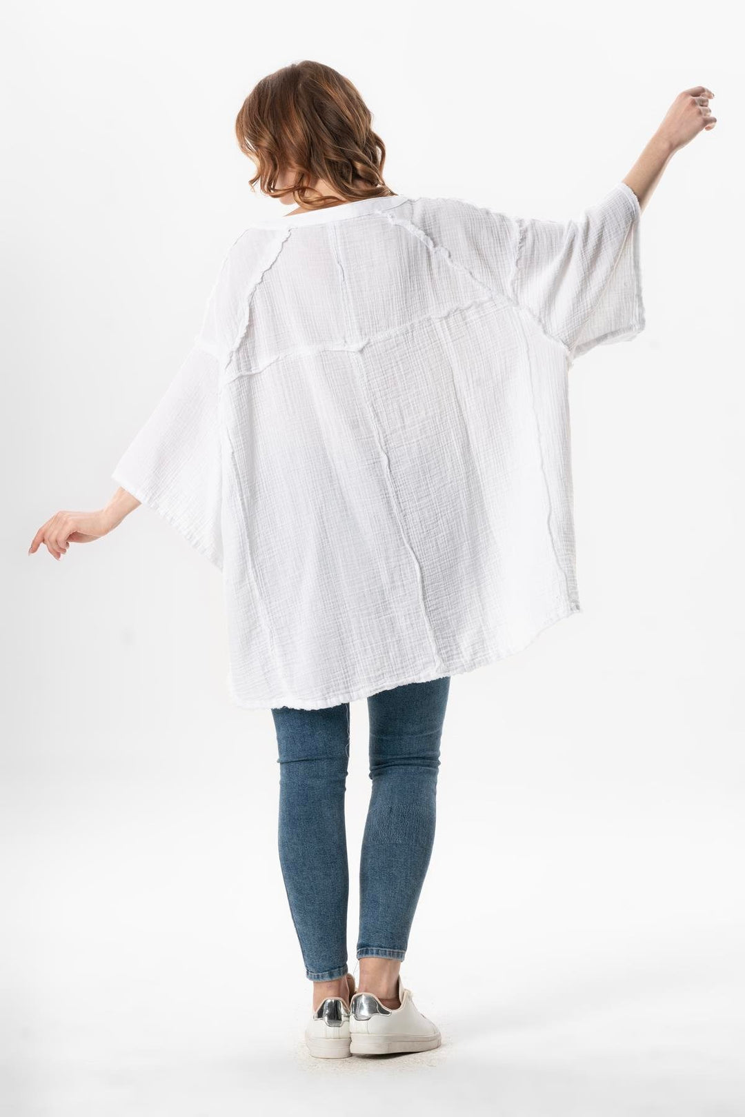 Back view of white gauze top featuring breezy fit and lightweight fabric perfect for summer.