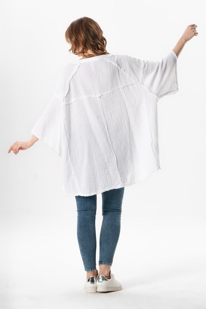 Back view of white gauze top featuring breezy fit and lightweight fabric perfect for summer.