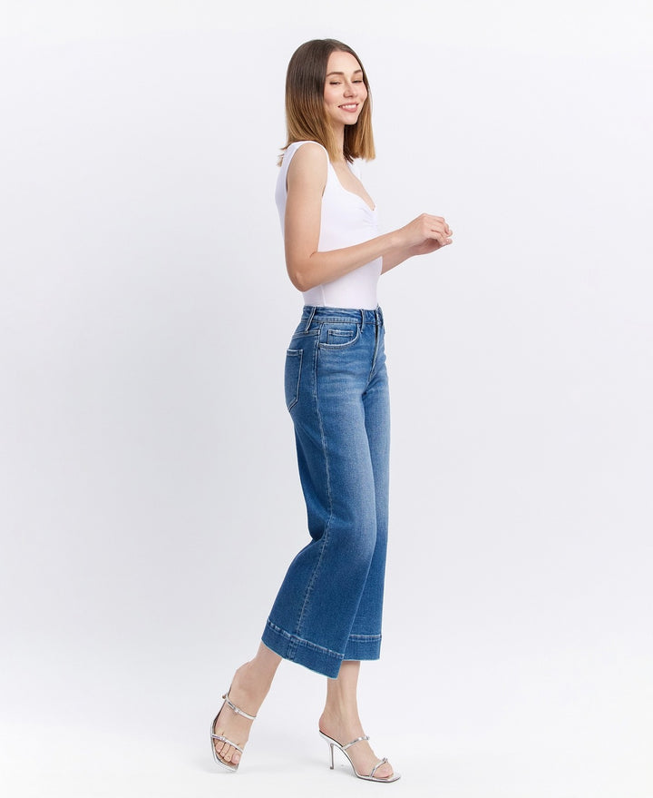 Side view of high-rise wide-leg cropped jeans featuring relaxed fit and slightly frayed hem