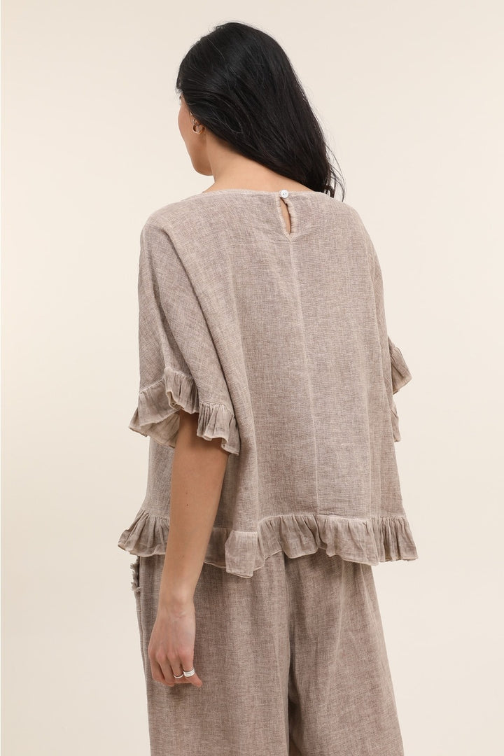 Back view of tan Italian linen blouse featuring breathable fabric and timeless design
