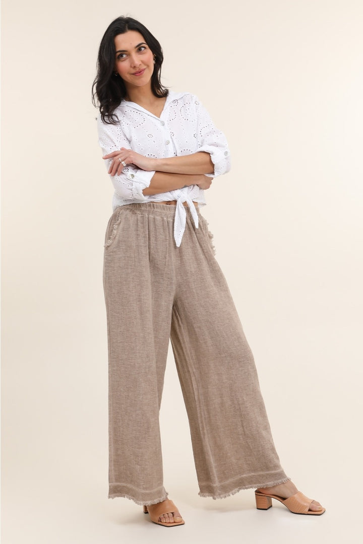 Casual outfit featuring tan Italian linen pants paired with white blouse – effortless elegance