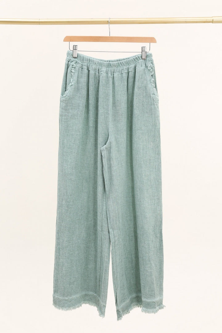 Casual outfit featuring green Italian linen pants paired with white blouse – effortless elegance