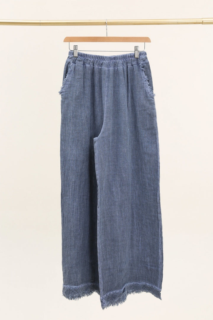 Casual outfit featuring navy blue Italian linen pants paired with white blouse – effortless elegance