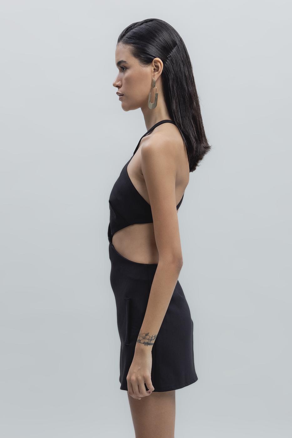 Side view of black banded mini dress highlighting the body-hugging fit and sleek finish