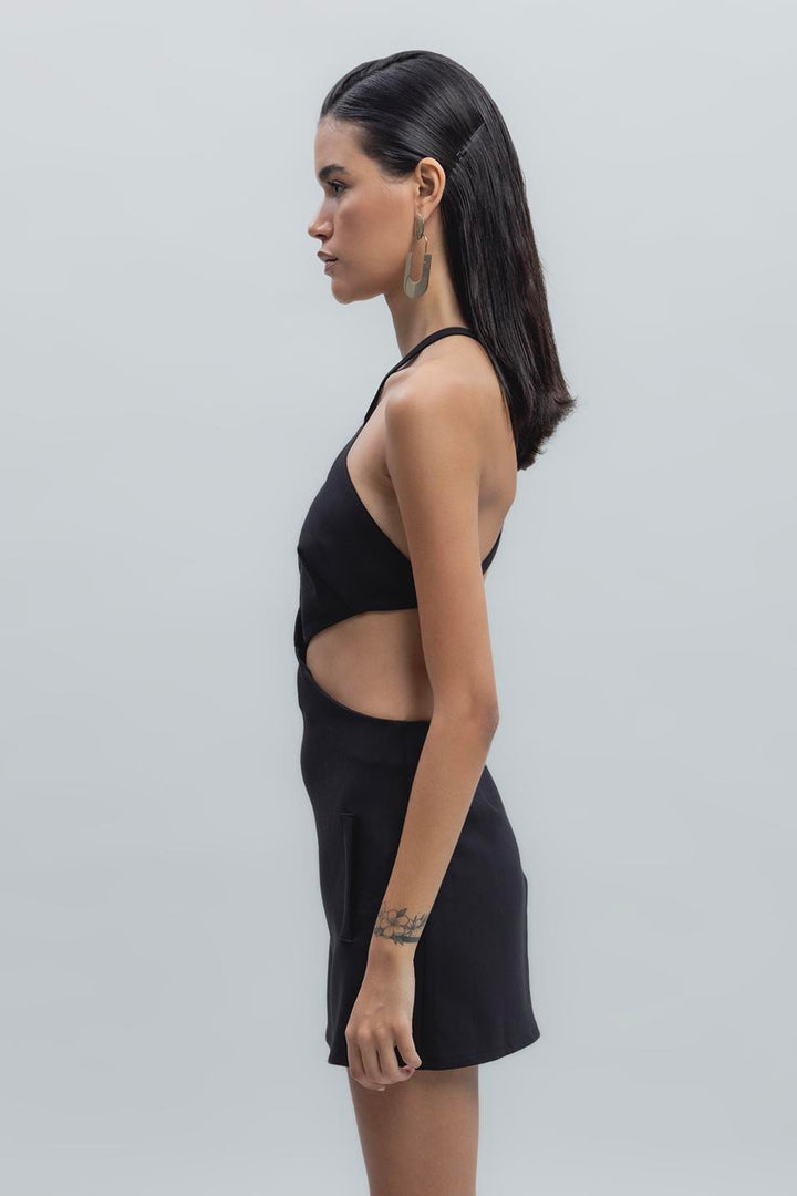 Side view of black banded mini dress highlighting the body-hugging fit and sleek finish