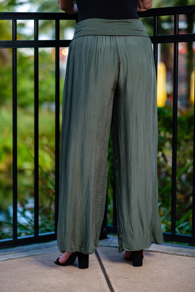 Back view of Tees By Tina army green silk pants with flowy silhouette and comfortable waistband
