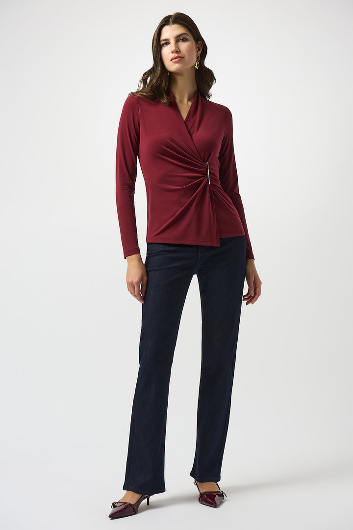 Woman wearing a red top and black pants on a white background