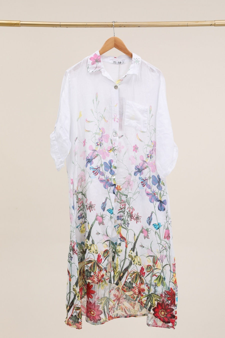 Close-up of white linen fabric featuring subtle floral pattern and lightweight texture
