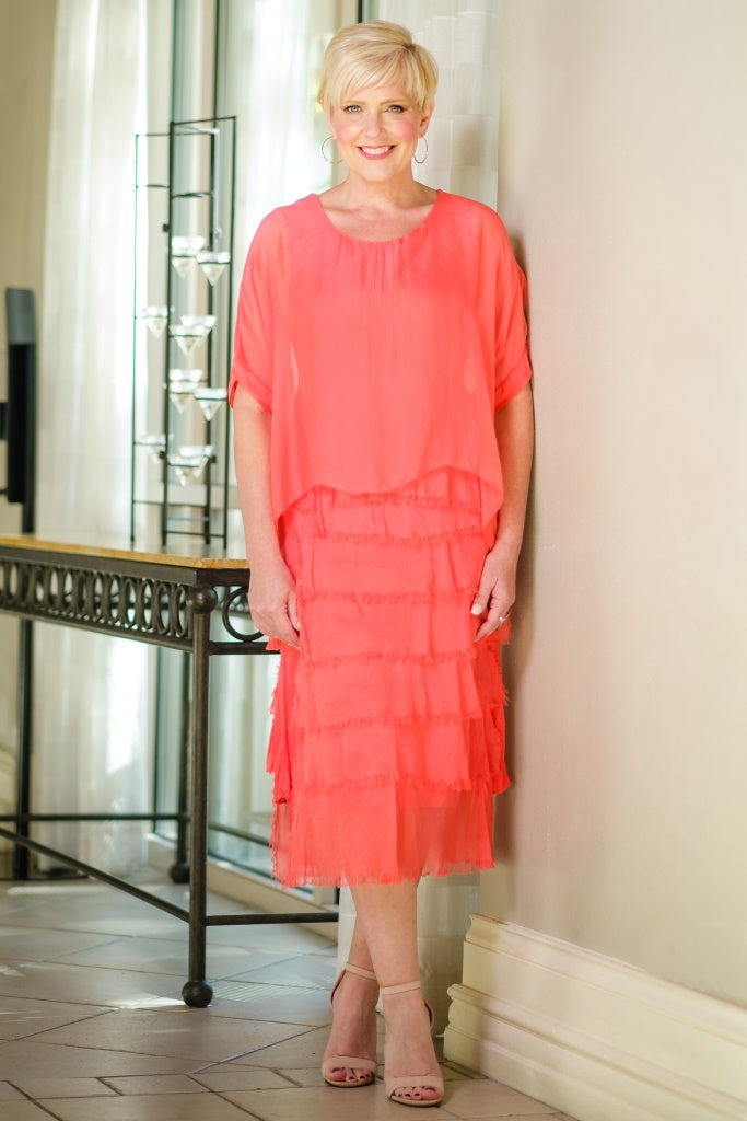 Coral silk dress with tiered ruffles, scoop neckline, and relaxed fit – made in Italy