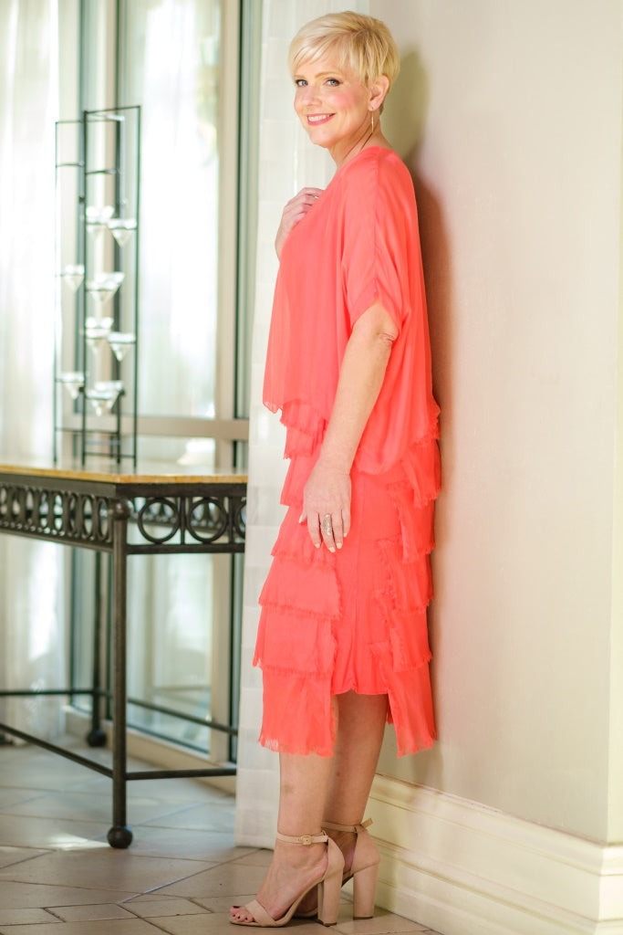another Side view of coral tiered silk dress featuring flowing layers and airy summer silhouette