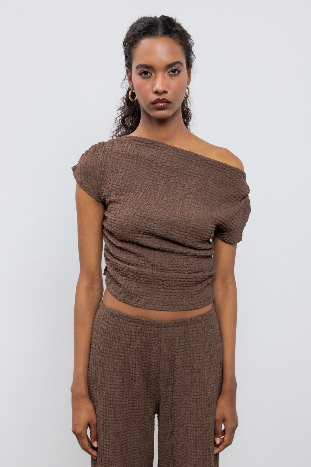 Brown textured top featuring asymmetrical shoulder design and relaxed fit – made in Türkiye