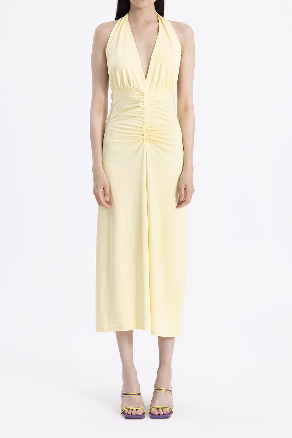 Close-up of 94% polyamide and 6% elastane fabric in butter yellow, showcasing smooth texture