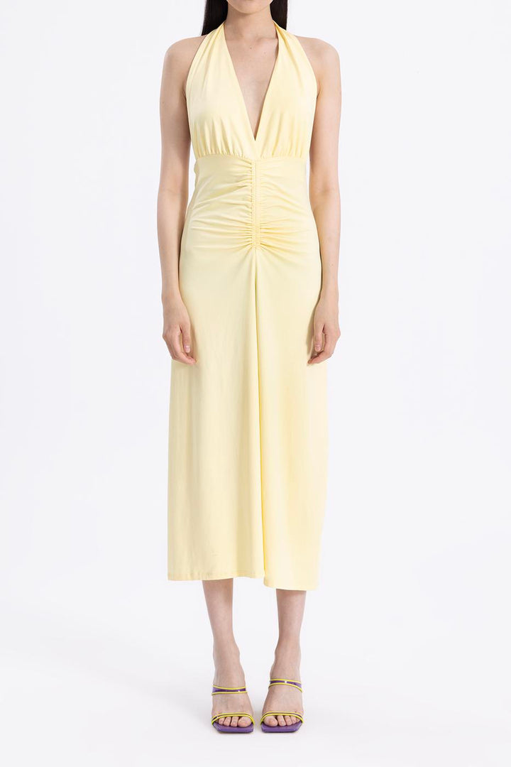 Close-up of 94% polyamide and 6% elastane fabric in butter yellow, showcasing smooth texture