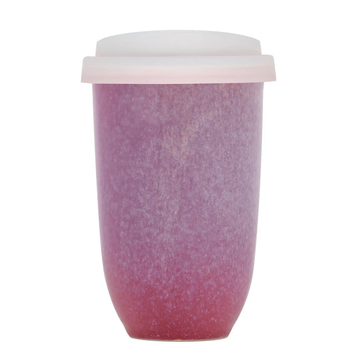Pink textured tumbler with a white lid on a white background