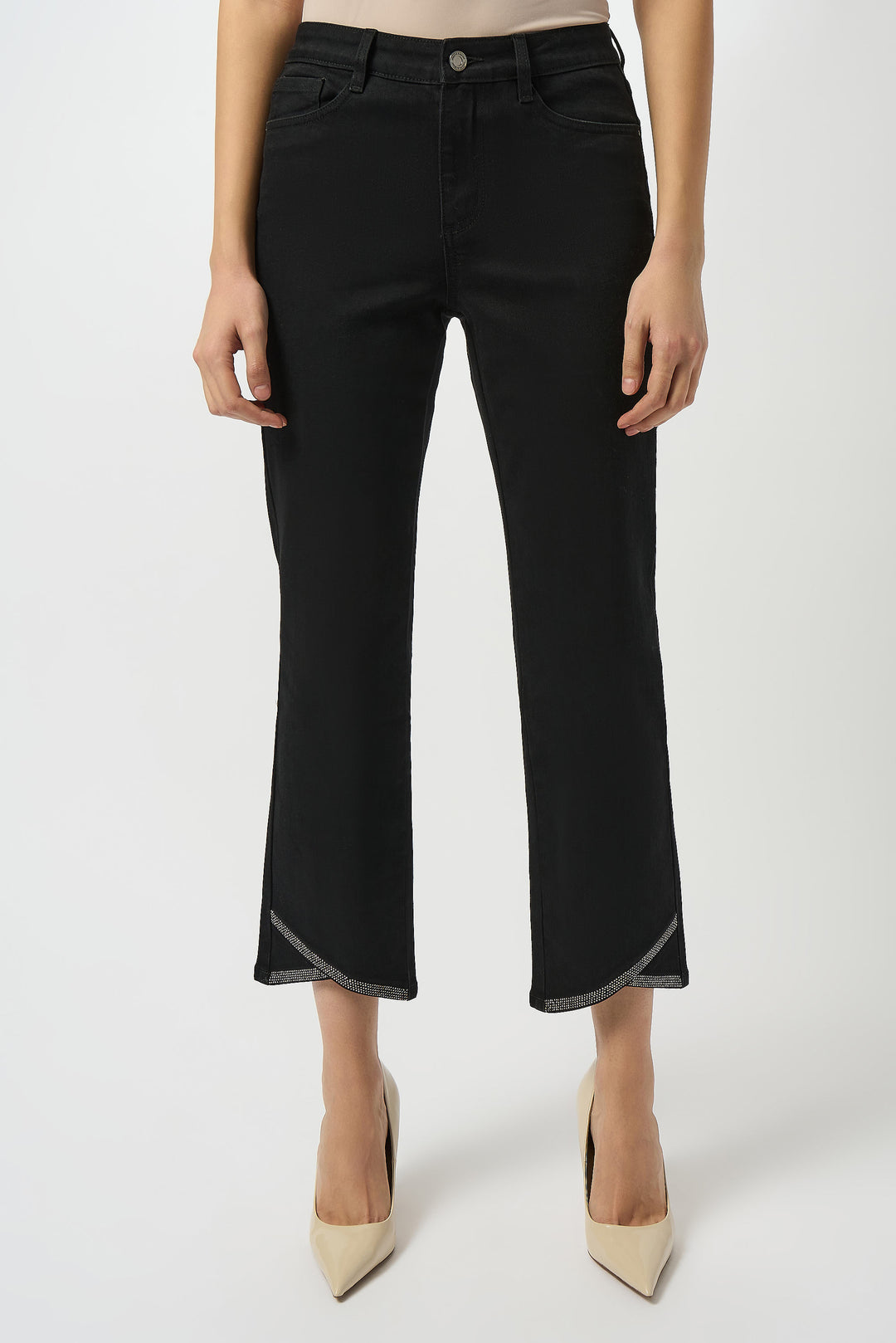 Black pants worn by a person on a white background
