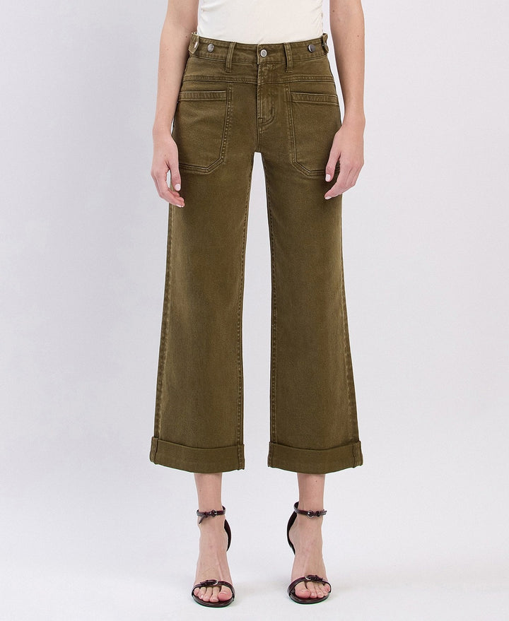 Person wearing olive green wide-leg pants on a white background