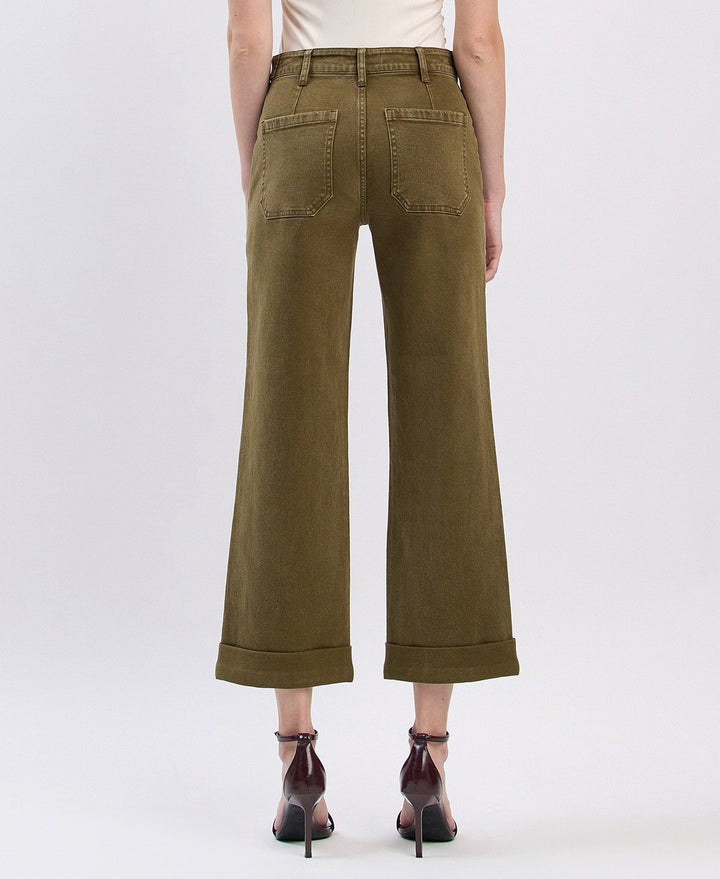 Person wearing olive green wide-leg pants on a white background