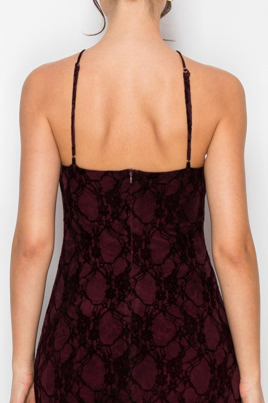 Lace dress with thin straps on a plain background