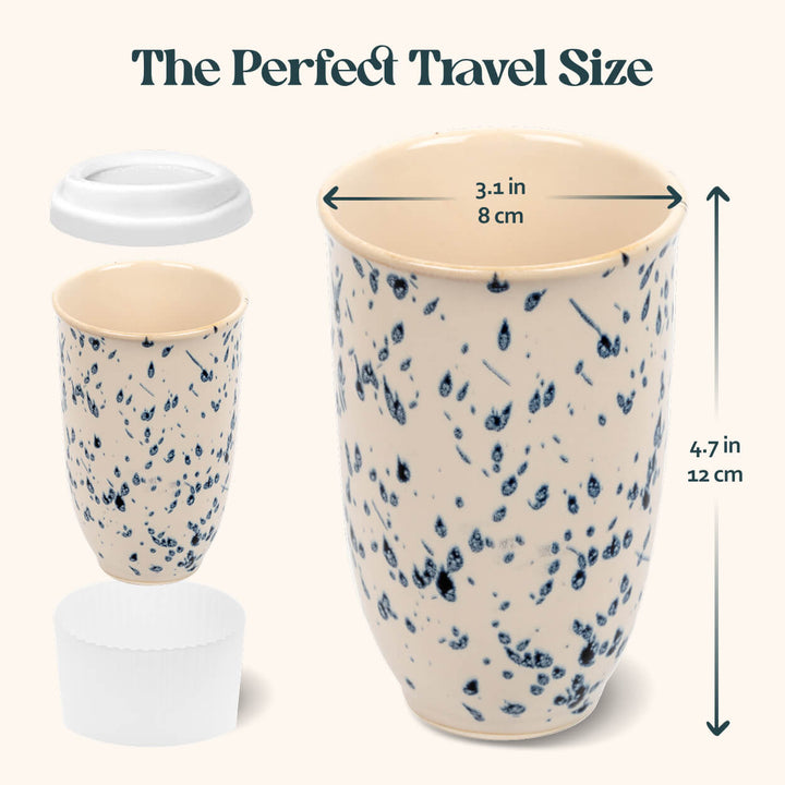 Speckled ceramic travel mug with measurements on a white background