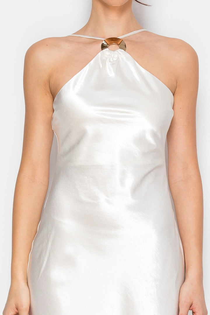 White satin halter neck dress on a plain background