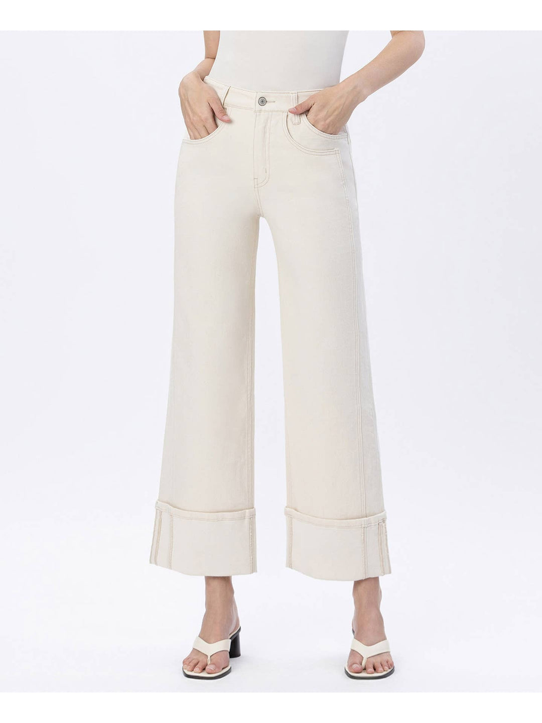 White pants worn by a person on a white background