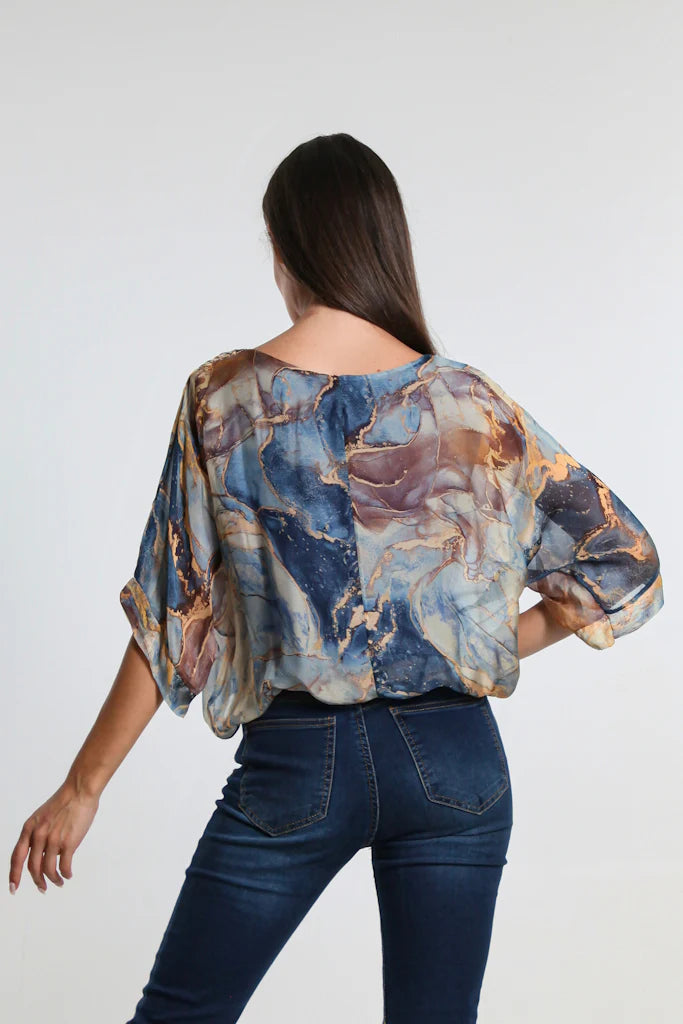 Back view of Italian-made navy silk blouse featuring elegant marble design and relaxed fit