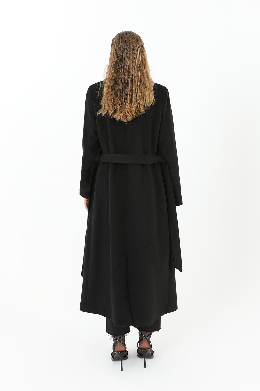 Person wearing a black coat on a white background
