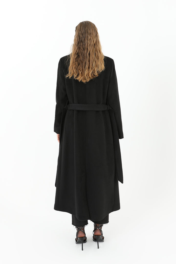 Person wearing a black coat on a white background