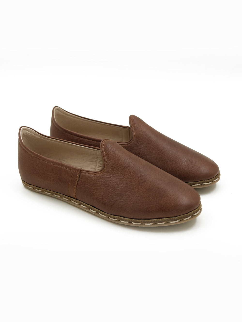 Side profile of handcrafted walnut brown leather slip-on shoes featuring premium cow leather​