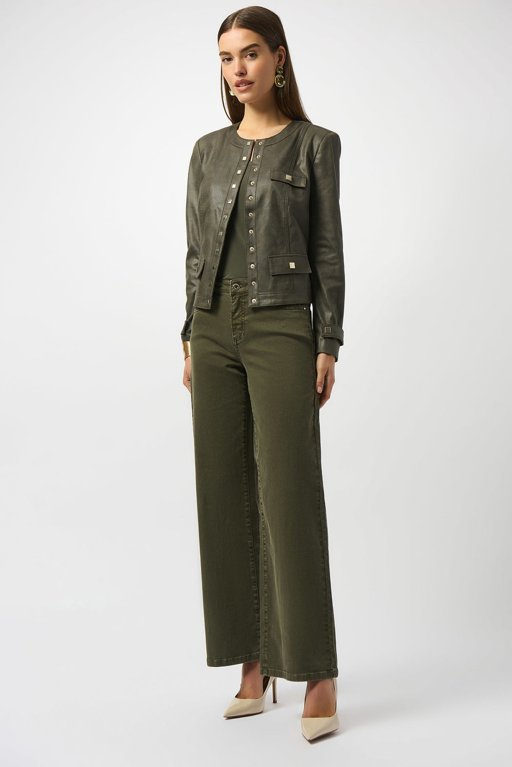 Woman wearing a green jacket and pants on a white background